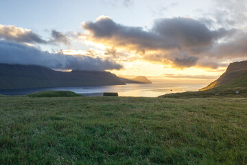 Obraz premium Sunset over the fjord. Faroe Islands rural landscape. 
