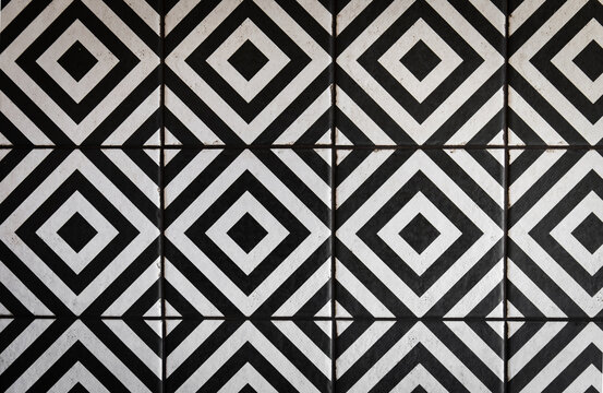 Black and white plate in a geometric pattern on the floor, minimalist design.