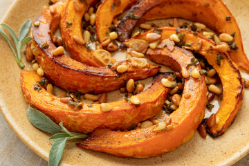 Roasted Red Kuri Squash with sage and pine nuts. - obrazy, fototapety, plakaty