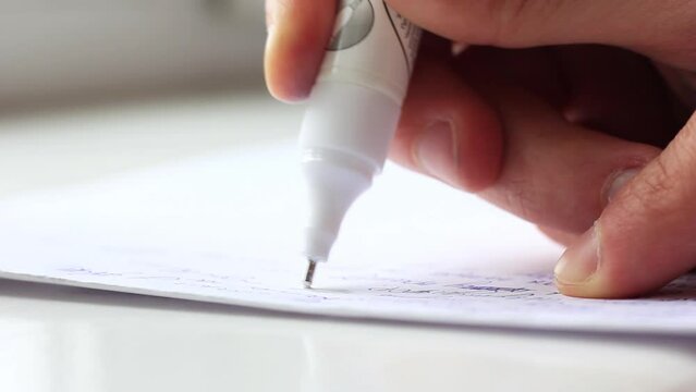 Man's hand with the help of a proofreader sketches the mistakes