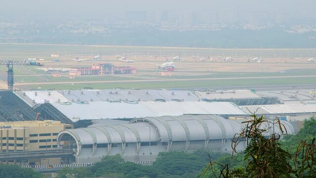 View of planes in an airport from a hilltop