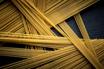 Italian spaghetti on a black slate stone background with space for your text. concept. geometry. food. style