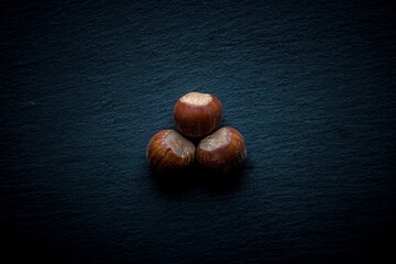 different nuts on a dark background. ripe nuts.  nuts in the shell