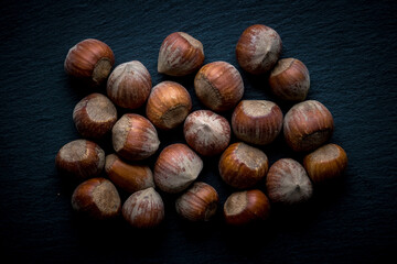 different nuts on a dark background. ripe nuts.  nuts in the shell