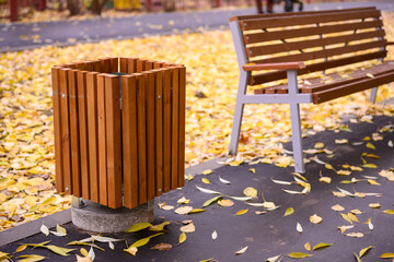 Wooden bench and trash can in the park
