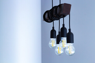 The lamp on the ceiling of the light bulbs located on the wires.