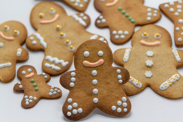 gingerbread man cookies decorated with icing sugar on white background. Christmas food, pastry background. New Year theme. Merry Christmas and Happy New Year Holidays greeting card, frame, banner