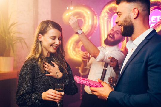 Couple exchanging gifts while on the birthday party or new years eve