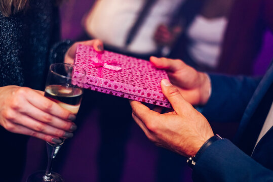Couple exchanging gifts while on the birthday party or new years eve