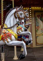 Fototapeta na wymiar Toy horses on a children's carousel in the park