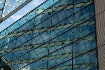 Fototapeta na wymiar Modern business office building with glass facade on a blue sky background