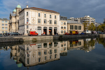 Paris, France - 10 31 2022: Ourcq canal. View of the Canal of the Basin of the villette with reflections of fire station buildings