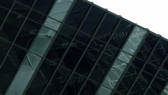  Black glass office. Stock footage. Black windows of a tall building at a height that is made in a certain style.