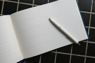 Guestbook and white pencil, top view