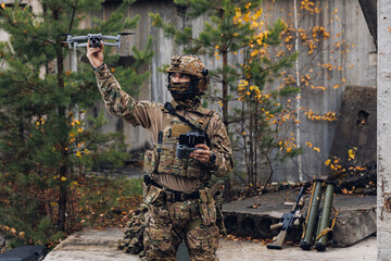 Soldier engineer is preparing reconnaissance drone for flight. Concept military use of quadrocopters