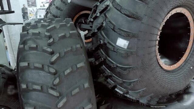 Huge new all-terrain vehicle wheels with great off-road properties as samples at the exhibition. Shot in motion. Closeup