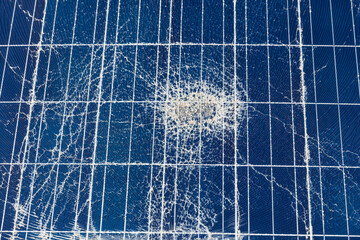 Broken destroyed cracked hole in solar panel after hail storm