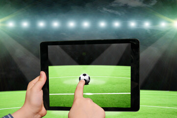 Swiping by finger on tablet screen, soccer - 544198516