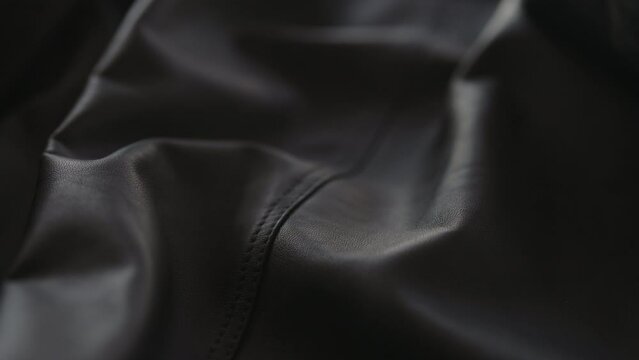 Slow motion handheld shot of soft gray leather jacket