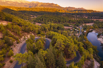 Naklejka premium Winding road and stone bridge with river from Koprulu Tazi Canyon. Manavgat Antalya Turkey aerial top view