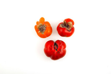 Three deformed Persimmon fruits on white background. Funny Concept - Reduction of organic food...