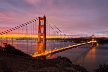 Fototapeta na wymiar San Francisco Landmark Illuminated During a Cloudy Pink Sunrise