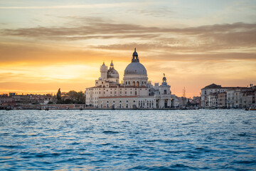 View of Venice Grand Canal and Santa Maria della Salute church in the evening and sunset. Piazza...
