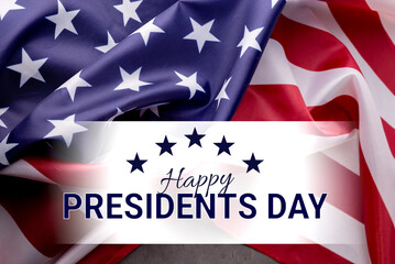 Happy Presidents Day Concept with the US national Flag against a dark grey background.