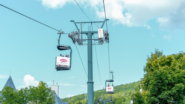Sightseeing views by cable car at Mont Tremblant ski Resort in summer. Ski resort village view from open funicular cabin. Mont-Tremblant, Quebec, Canada - 22.09.2022