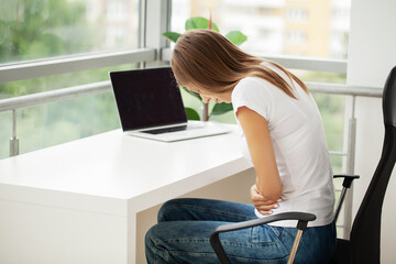 Business woman feeling painful from stomach ache illness during working at office