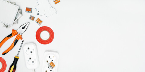 Different electrical equipments and tools on grey background. Banner with copy space.