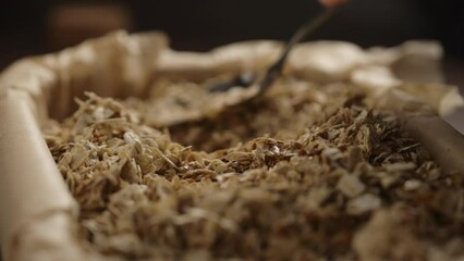 Slow motion making granola in baking tray, tamp