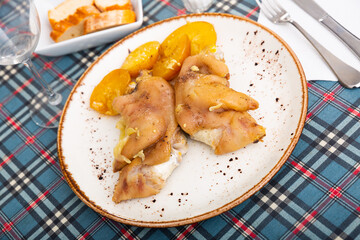 Delicious stewed pig trotters served with potatoes on white plate