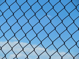 Fototapeta na wymiar chain link fence with blue sky