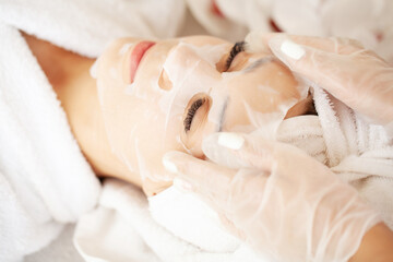 Cheerful woman with a towel on her head face mask clean skin
