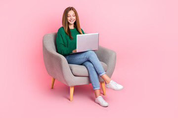 Full length photo of cheerful cute young lady wear green sweater typing sansung modern device isolated pink color background