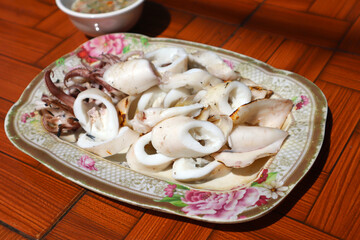 Grilled Squid with spicy sauce in Thai style. Most Popular Thai Seafood Dishes.