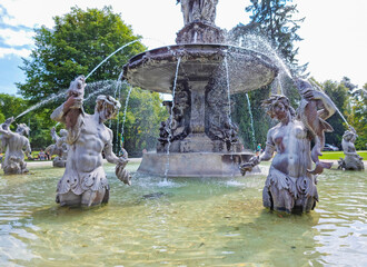 Beautiful fountain in the city park Stadtpark, a green island in the middle of the city center of Graz, Styria region, Austria. Selective focus