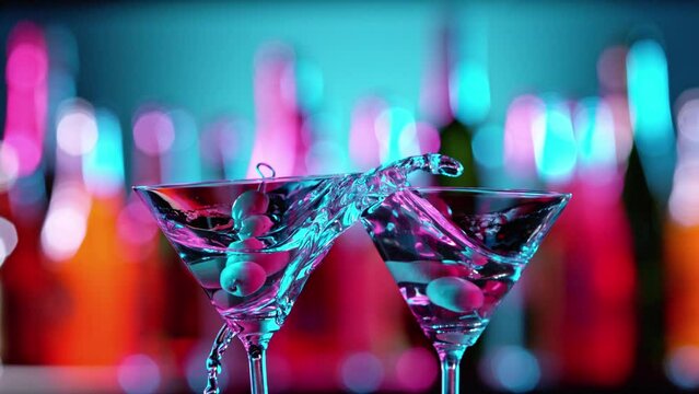 Super Slow Motion of Martini Cocktails Hitting Together in a Bar, Cheers Concept. Filmed on High Speed Cinema Camera