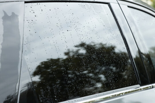 Drops of water on car window glass, closeup