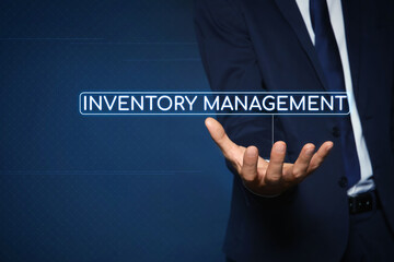Man touching virtual screen with text Inventory Management on color background