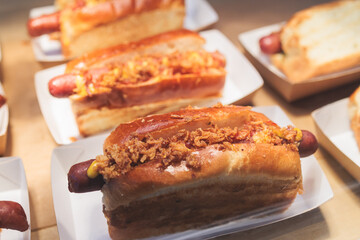 Hot dogs snacks on a table, variety of different hot dog with sausage and onion on beautifully decorated catering banquet table on a corporate christmas birthday party event or wedding celebration