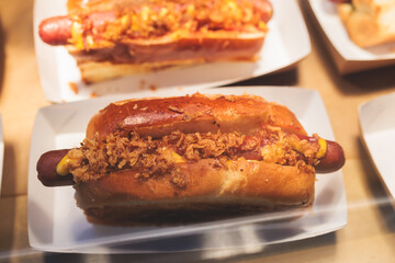 Hot dogs snacks on a table, variety of different hot dog with sausage and onion on beautifully decorated catering banquet table on a corporate christmas birthday party event or wedding celebration