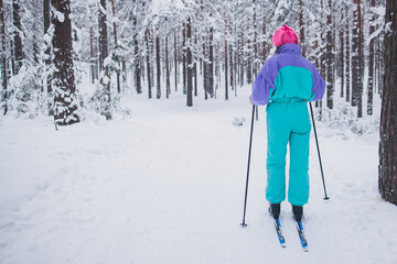 Beautiful cold forest view of ski run track on ski resort, winter day on a slope, pist, nordic skier on the track in winter, process of cross-country skiing in the woods