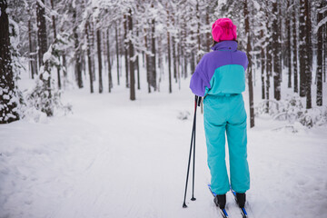 Beautiful cold forest view of ski run track on ski resort, winter day on a slope, pist, nordic skier on the track in winter, process of cross-country skiing in the woods