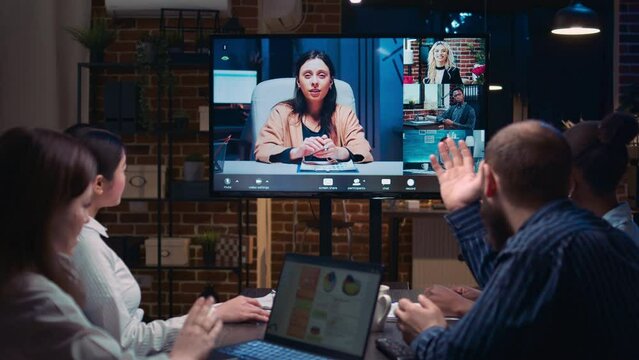 Remote team business meeting, coworkers talking in videocall at night time. Diverse people chatting in teleconference, colleagues brainstorming in videoconference in office zoom in