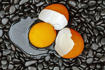 chicken eggs laid on black stones