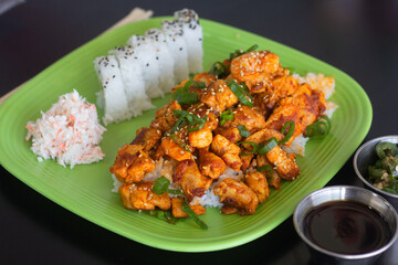 Asian sushi roll with toppings and vegetables. Filled with crab, avocado, cucumber and sauce.