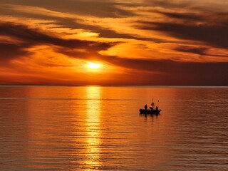 Naklejka na ściany i meble fishing boat at sunset