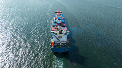 cargo maritime ship with contrail in the ocean ship carrying container and running for export...